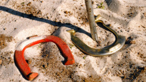 Courtesy Getty Images A photo of two horseshoes laying in sand, promoting the National Horseshoe Pitchers Association's world championships.