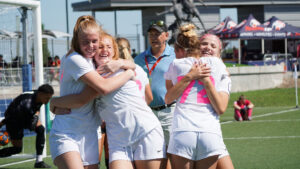 A group of youth soccer players hug after winning at the US Youth Soccer National Presidents Cup in Wichita, Ks. 