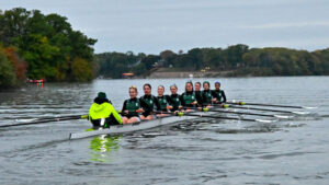 A group of rowers navigate there way across the water. 
