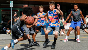 A group of youth play basketball during the Everett 3on3 Basketball Tournament. 