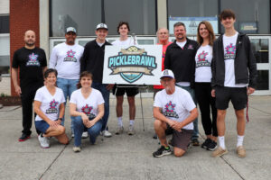 Courtesy City of Salem (Va.) A group of people gather to celebrate the announce of a pickleball event in Salem. Va. One of them holds a sign.