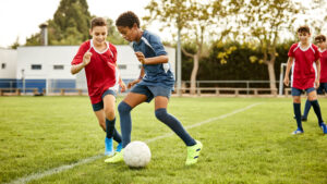 A group of young athletes play soccer