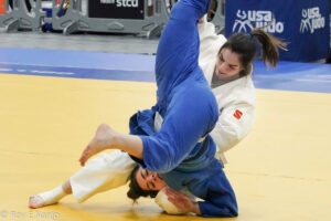 Two female judo participants grapple during at match. 