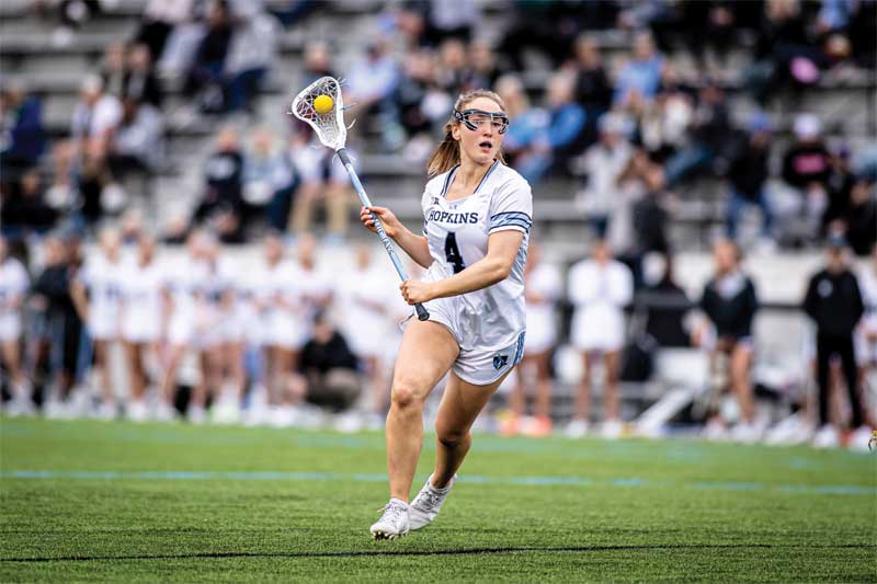 Courtesy John Hopkins Athletics A female field hockey player readies to shoot the ball.