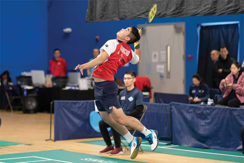 (c) Getty Images A badminton player leaps in the air to attempt a shot.