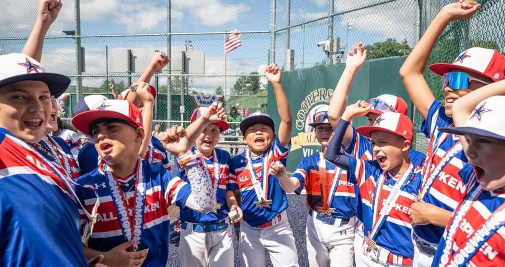 Little League baseball players cheer after a win.
