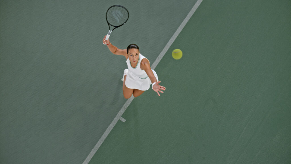 A female tennis player playing in a tennis court