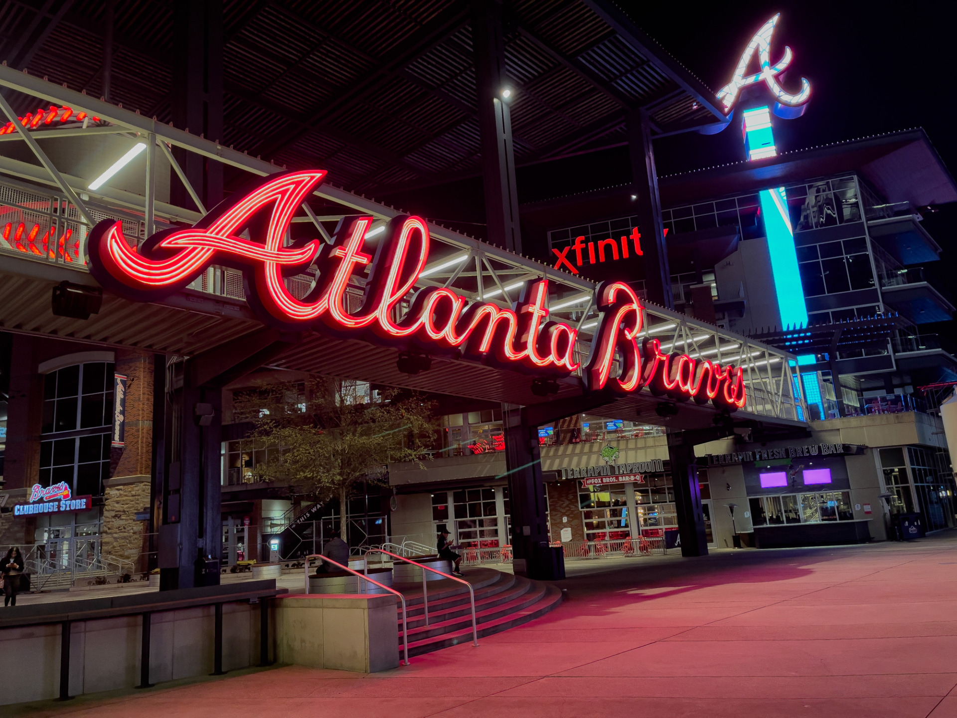A Red Atlanta Braves sign above the entrance of Truist Park.