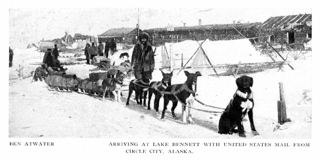 A black and white photo of U.S. mail carrier Ben Atwater mushes dog sleds to deliver mail in Alaska.