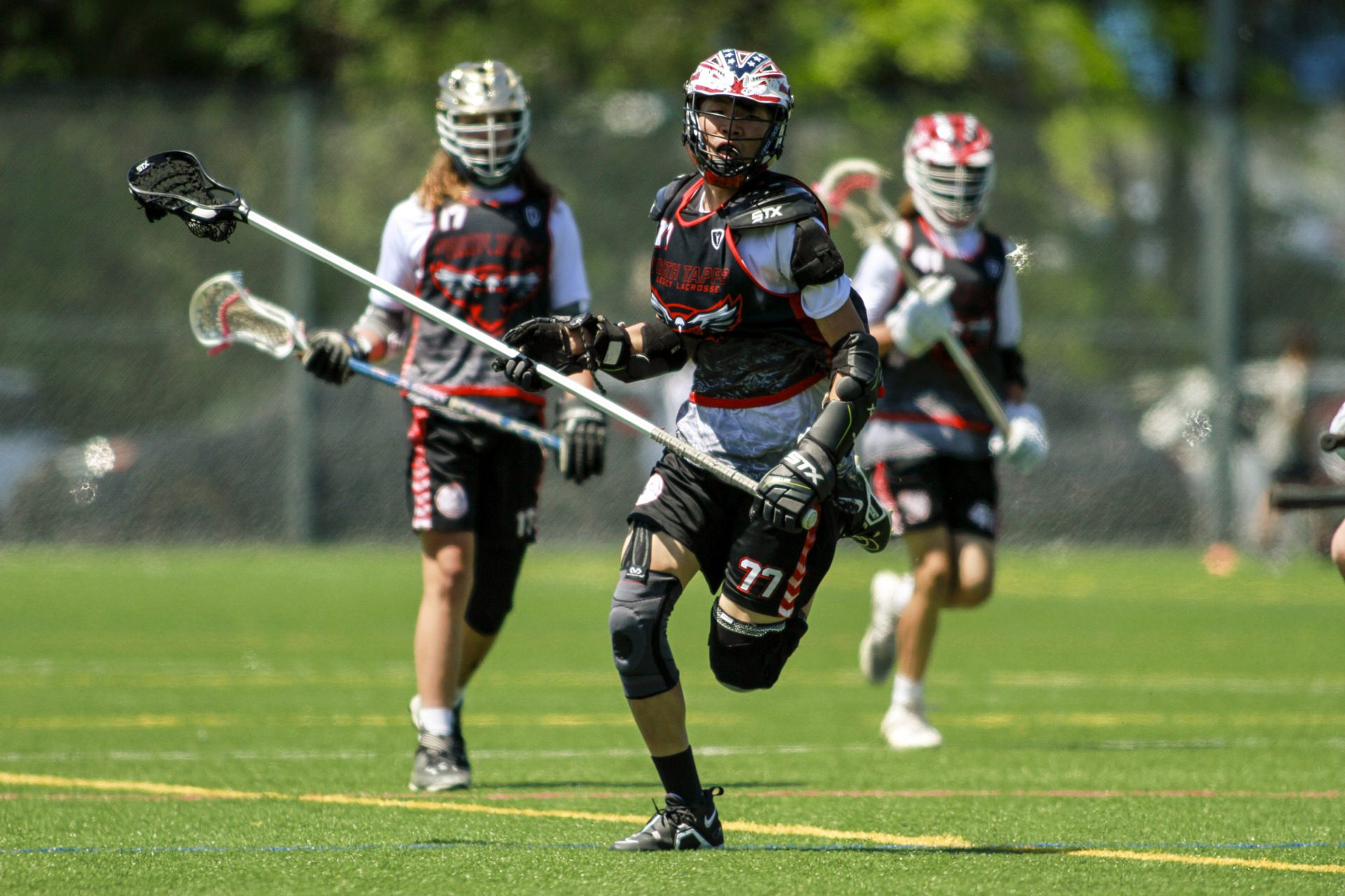 Lacrosse players playing a game.