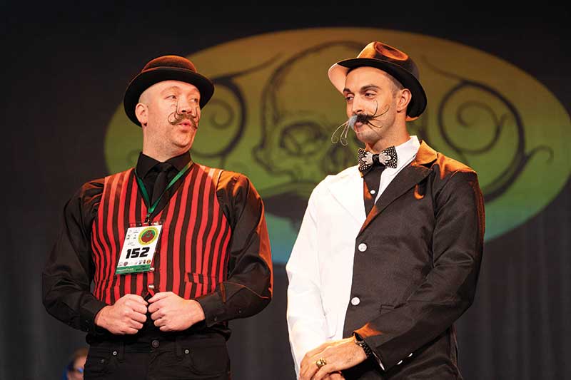 Two people with creative mustaches at the 2024 National Beard & Moustache Championship which was held November 2, 2024 at the Historic Everett Theatre in Everett, Washington.