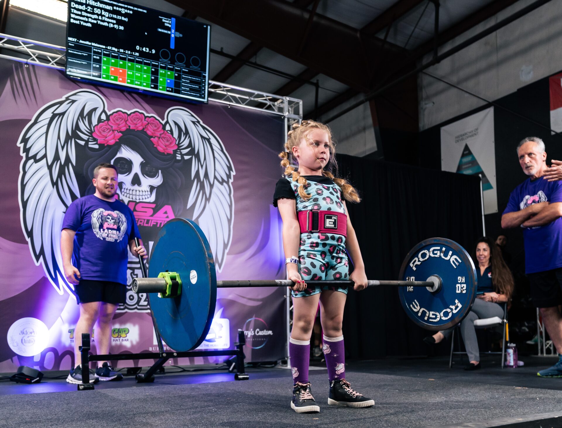 A young girl powerlifting