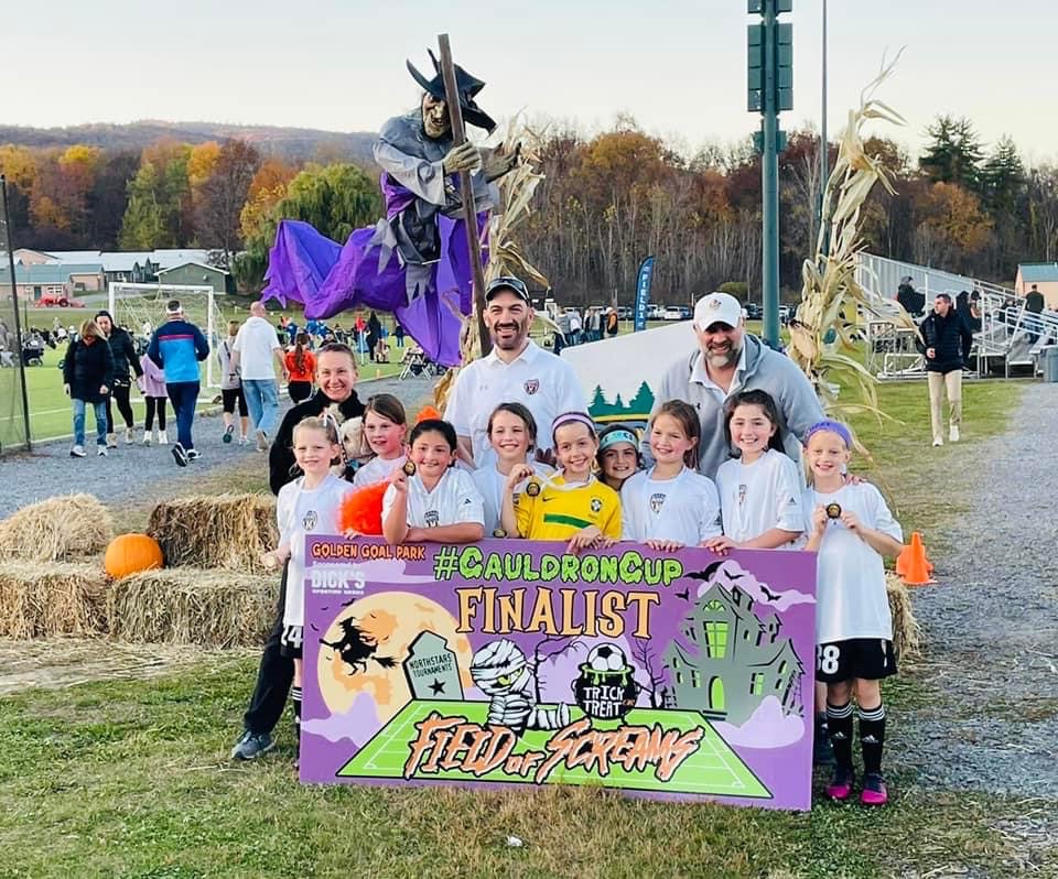 A soccer team of kids posing for a photo.