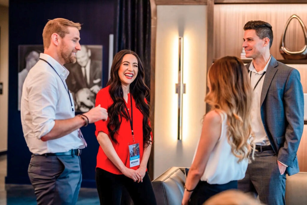 A group of people standing around talking.