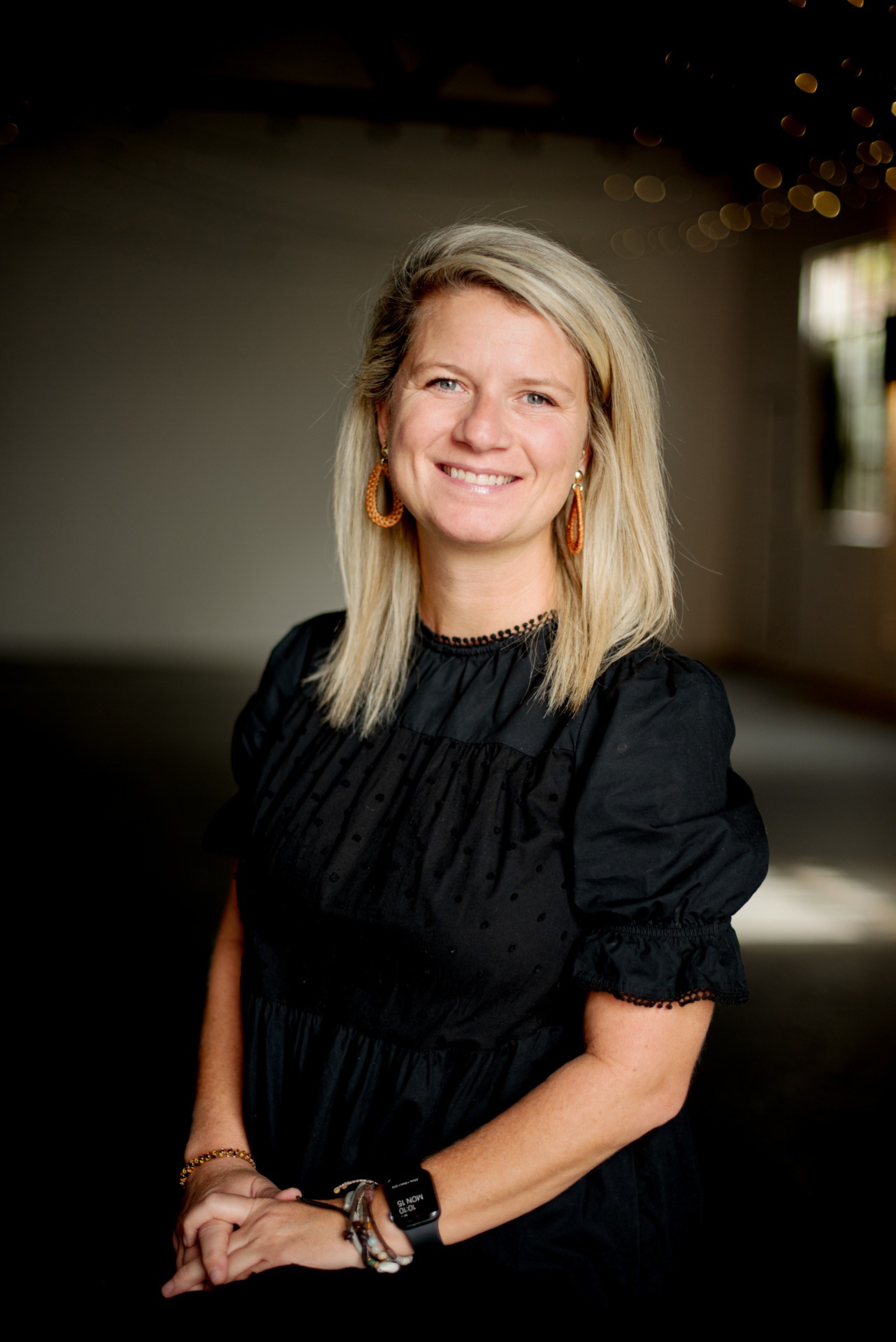 A headshot of Rachel Rogers wearing a black blouse and blonde hair.
