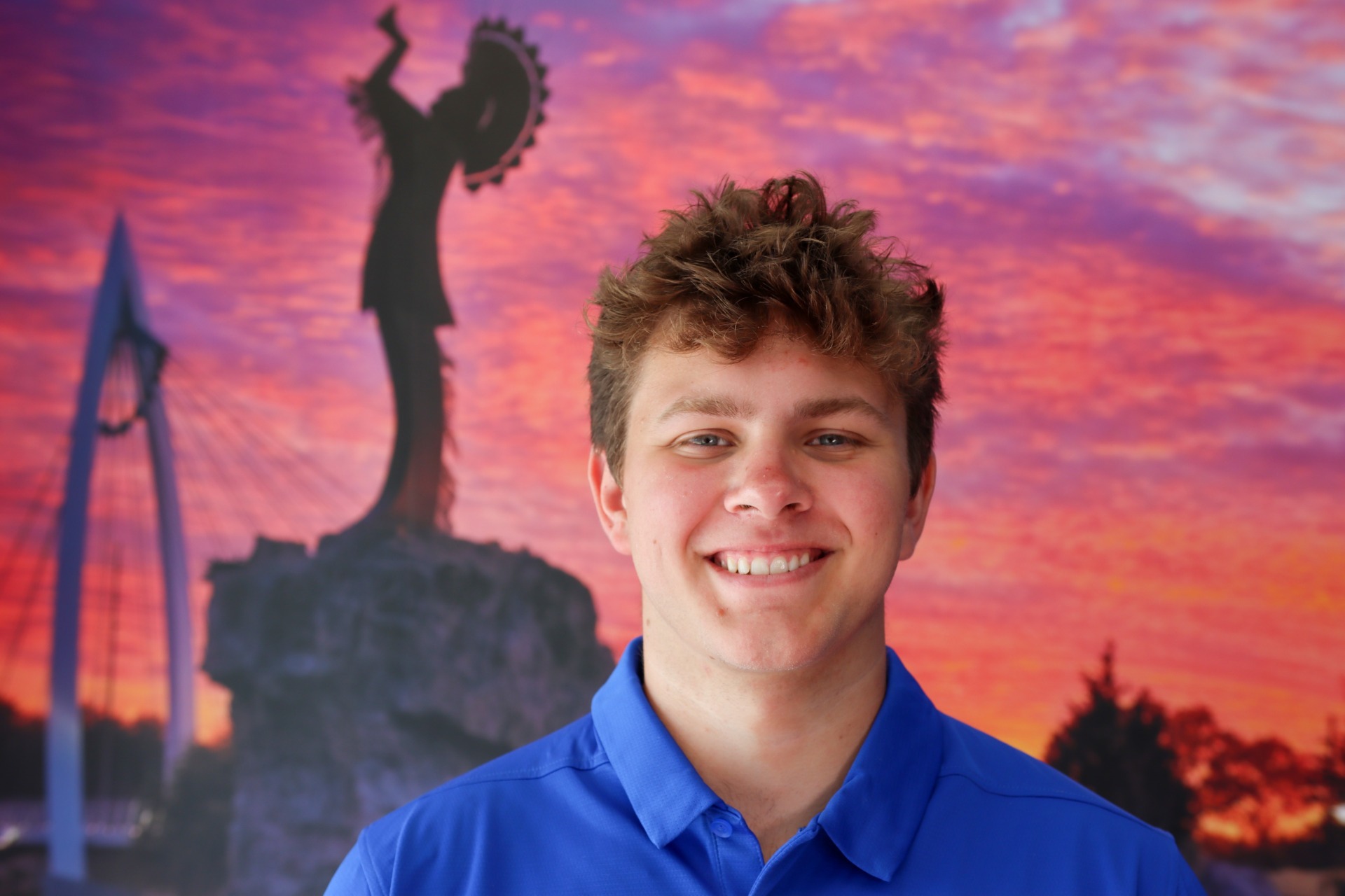 A headshot of Landon Arbuckle in a blue shirt.