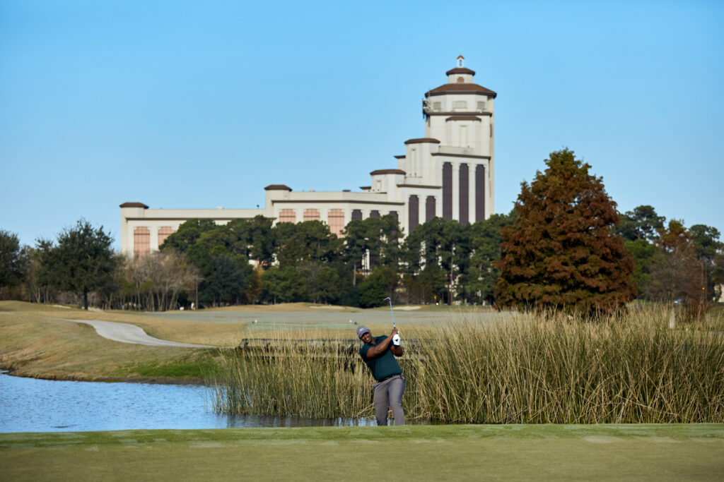 A golfer takes a swing on a course near Lake Charles