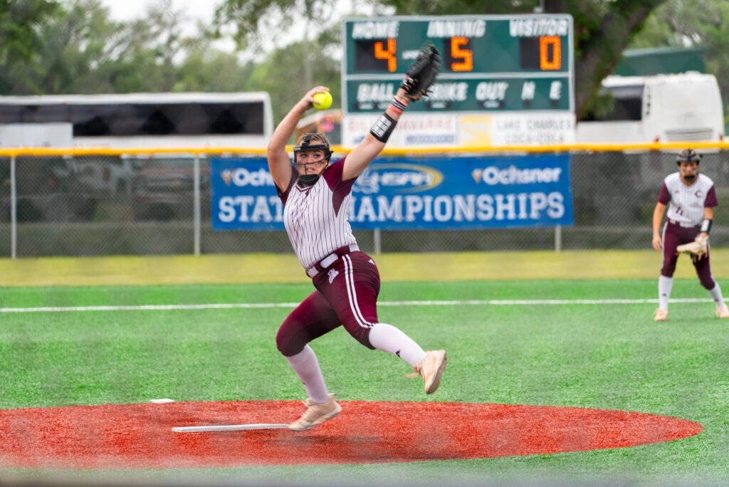 A pitcher winds up to let a softball fly.