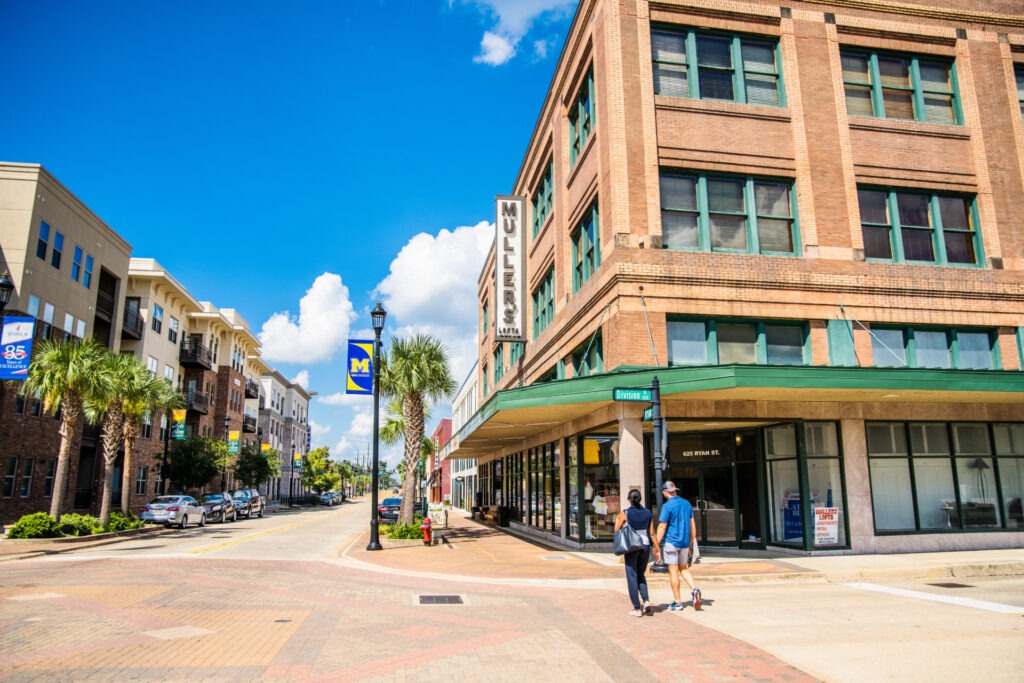 A couple walking hand in hand in downtown Lake Charles.